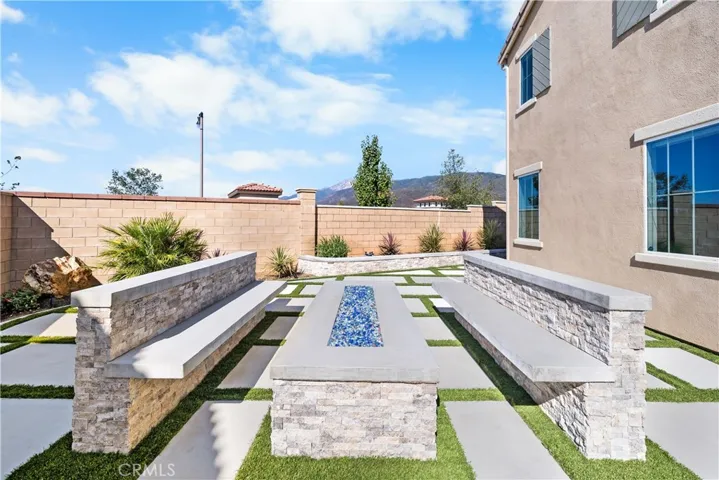 Custom water-wise landscaping w/ firetable & seating