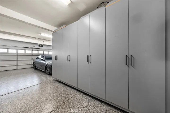 Garage w/ epoxy floor and custom cabinets