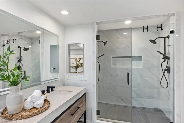 A separate walk-in shower with multiple shower heads!