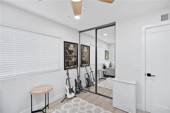 This third secondary bedroom features ceiling fan, mirrored closet doors and recessed lighting.