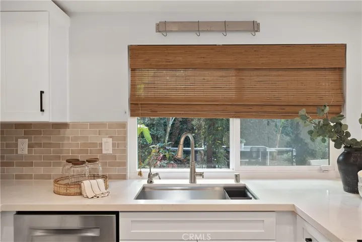 Kitchen overlooks gorgeous backyard.