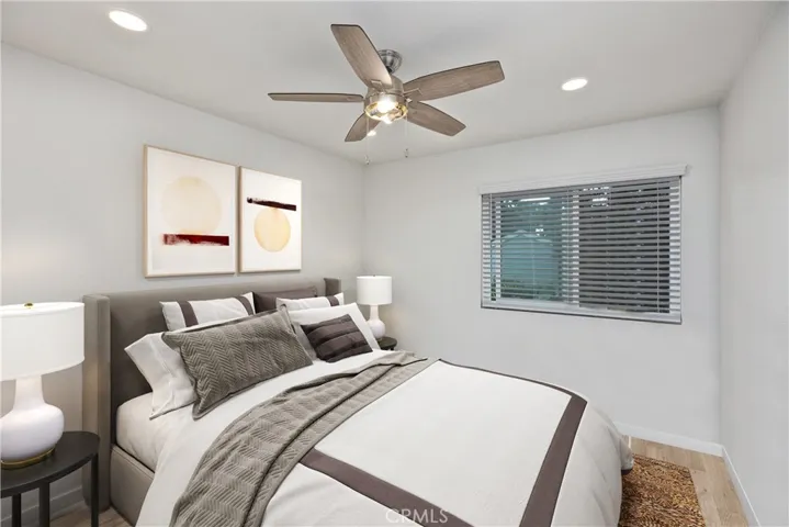 Another secondary bedroom that features ceiling fan and recessed lighting. This room is virtually staged.