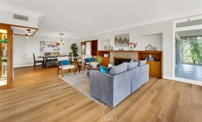 Spacious living room with fireplace ready for your Christmas stockings