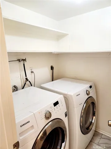 Downstairs laundry room with storage space