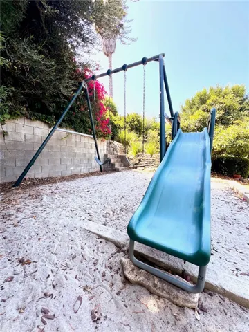 Inviting stone-lined walking path draws you down to multiple flat pads for entertaining and play.