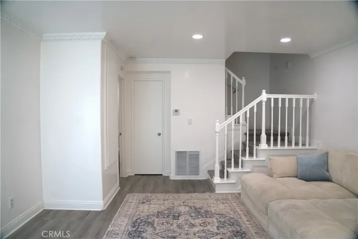 Living Room with updated lighting, wood flooring, paint