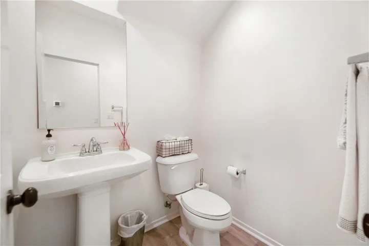 Downstairs half bath with beautiful pedestal sink.