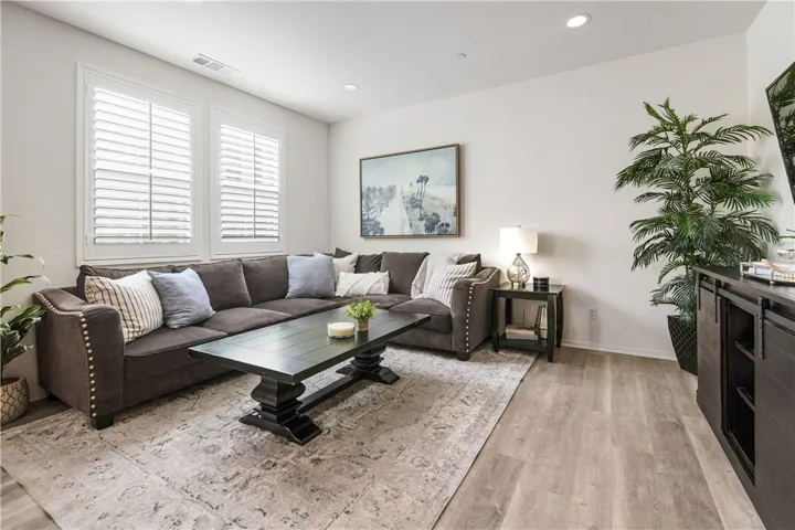 Upgraded touches - beautiful luxury vinyl flooring, custom shutters, recessed lighting.