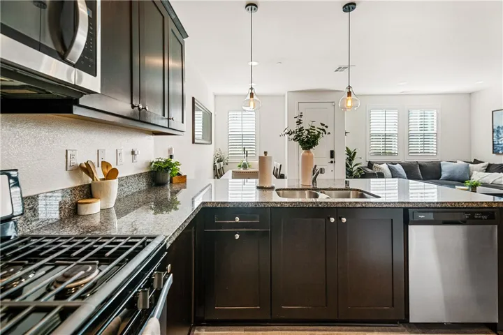 Kitchen features granite countertops, upgraded maple cabinets, and Whirlpool stainless steel appliances.