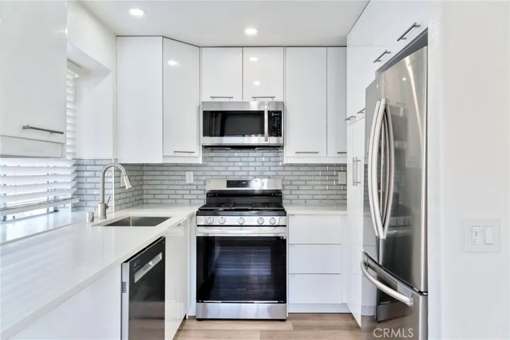 European Influenced Kitchen w/ Quartz and Glass Tile Backsplash