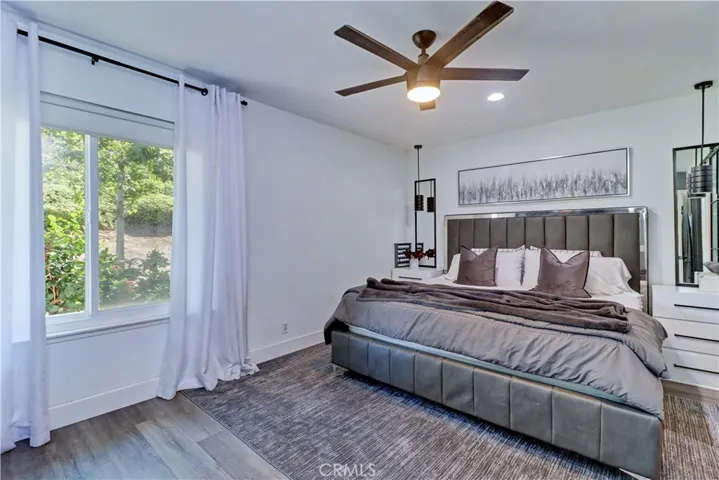 Primary bedroom with recessed lighting.