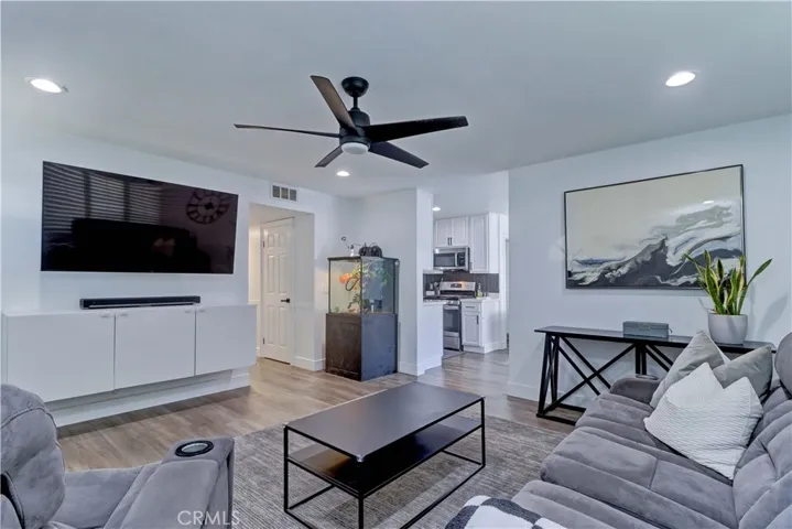 Spacious living room with recessed lighting.