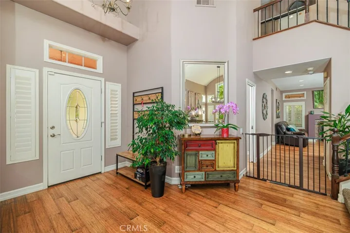 Looking back at the front entrance and down the hall toward the downstairs bedroom and family room