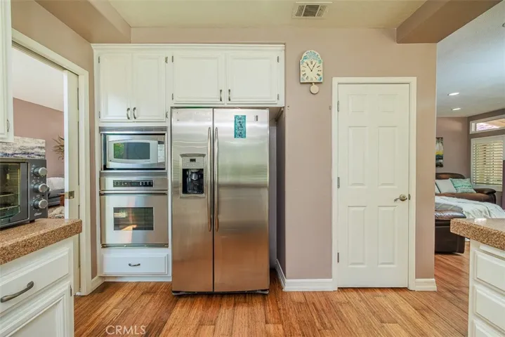 Stainless oven and microwave. Door into the walk-in pantry