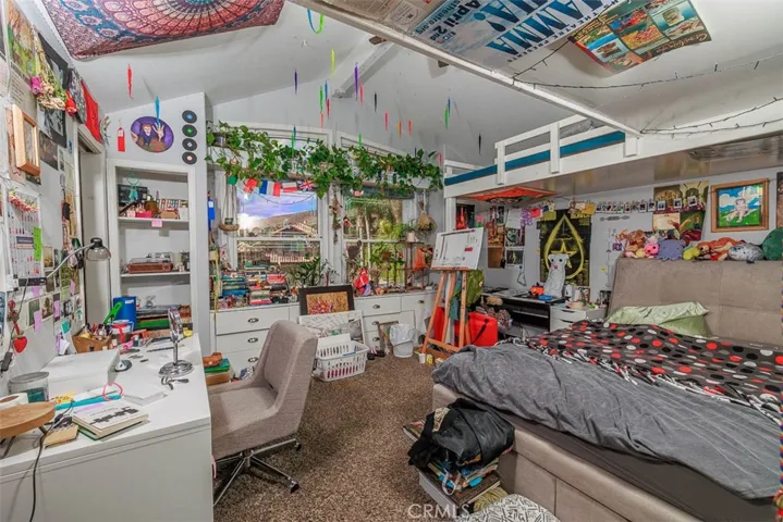 This is secondary bedroom #2 and is the larger of the secondary bedrooms. It features a walk-in closet and vaulted ceiling. There is also a built-in bunk bed