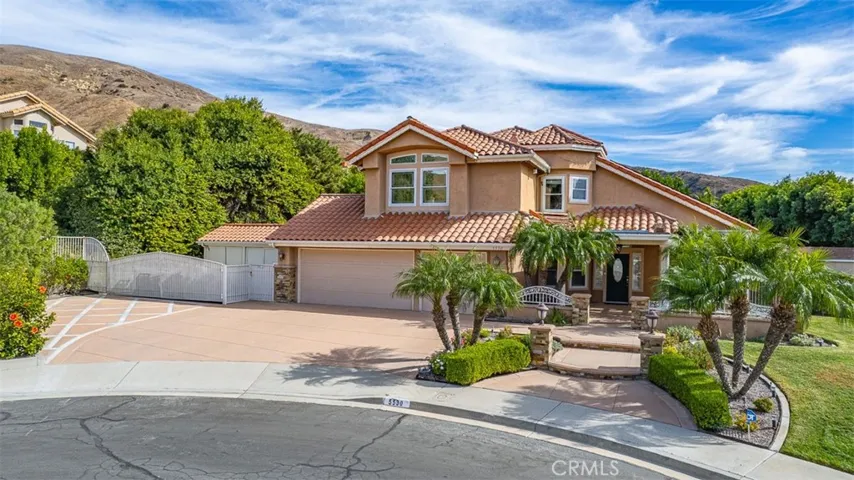 The large driveway and adjoining, gated RV area provides ample parking space. Beautiful mature landscaping and custom hardscape add to this oasis away from the daily grind