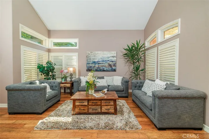 The living room sitting area with custom plantation shutters on the double-pane vinyl windows with beveled accents