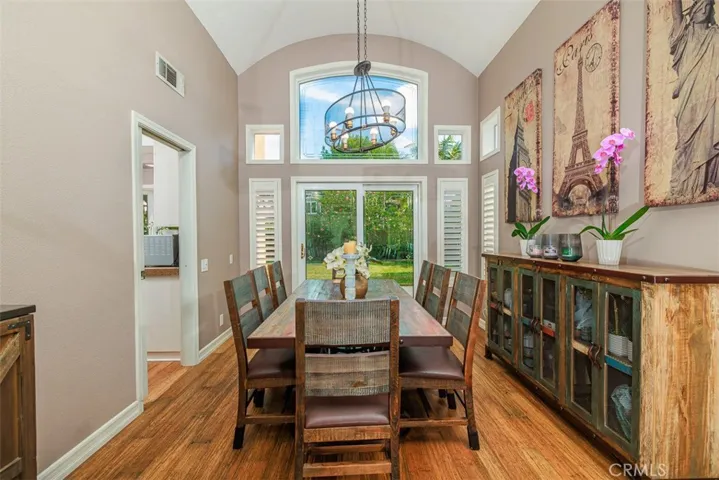 Formal dining area with volume ceiling has ample room to accommodate your large family gatherings. Door on the left conveniently leads into the kitchen. The sliding door at the far end opens into the back yard