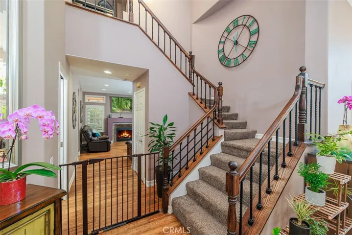 Looking down the hall into the family room. Stairway with wrought iron and wood railing leading to the second level