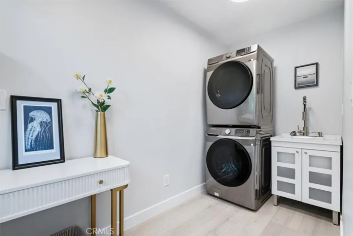Comes with new stacked fullsize washer and dryer and utility sink and cabinet.