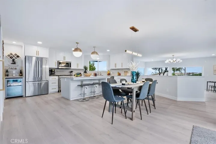 225 Travis kitchen and dining with laundry in distance.