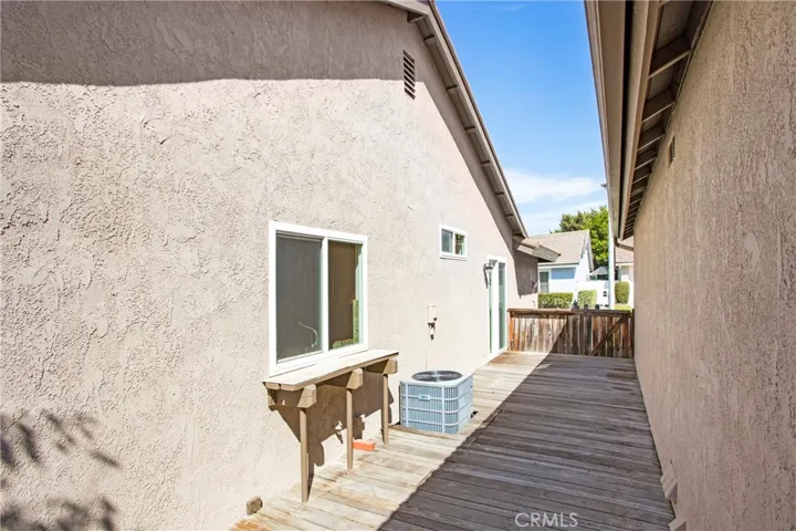 Side deck patio area with gated access to front yard