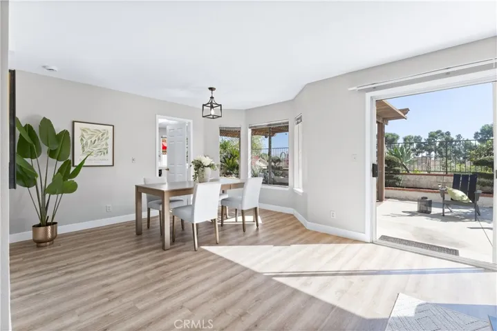 Great room/dining roo with natural light and sliders to the significant sized backyard and lanai