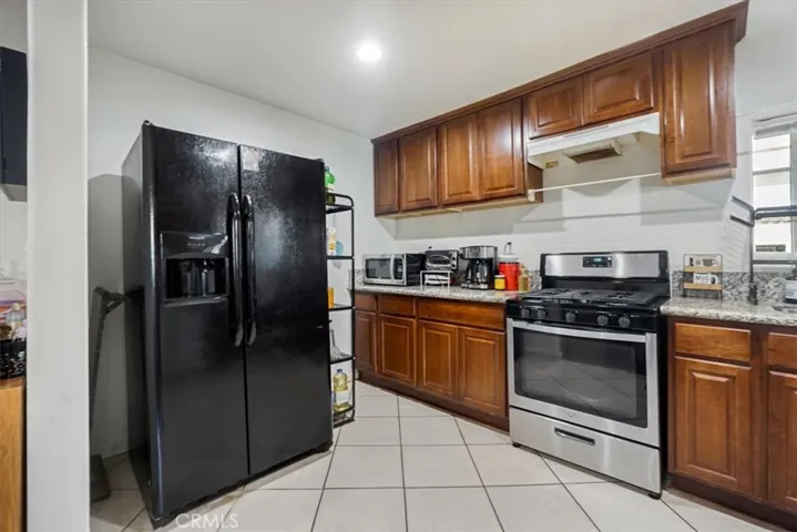 There is plenty of room for a large refrigerator in the kitchen.
