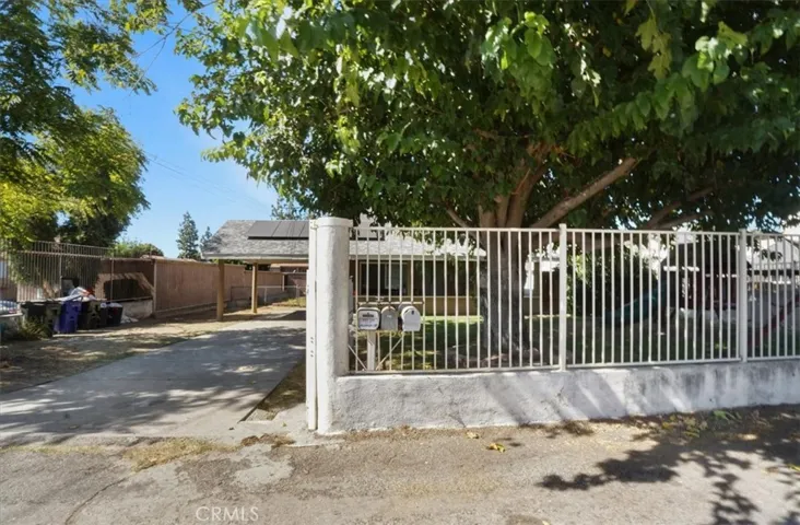 The front wrought iron fence and gate enclose the front yard.
