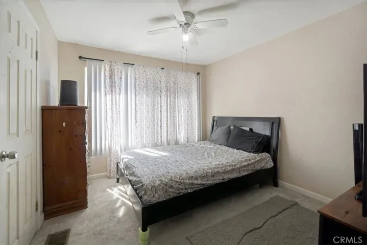 The roomy bedroom downstairs has large windows and a ceiling fan to keep it cool on those warm days.