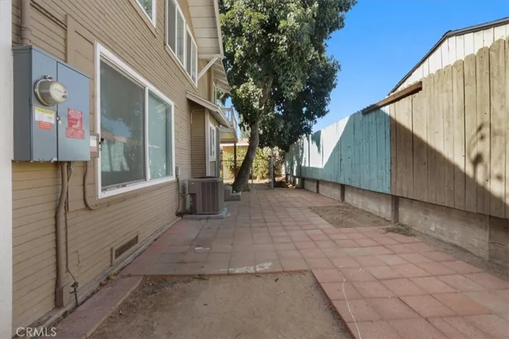 The side yard has pavers and an electrical and solar panel installed in 2022.