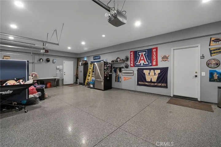 3 car garage with drywalled interior and coated floors