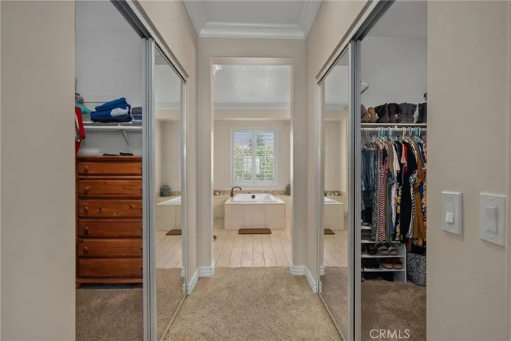Primary bedroom looking into primary bath and dual closets