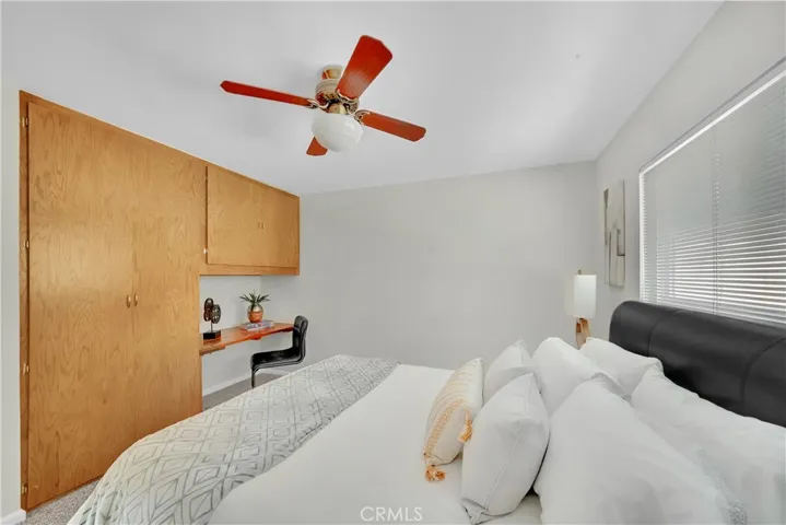 Bedroom 2 with built-in desk area and closet organizer