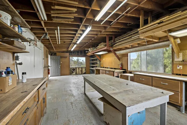 30x15 2-story workshop. Tons of open workshop space on top, and tons more of shelved storage space on the lower level.