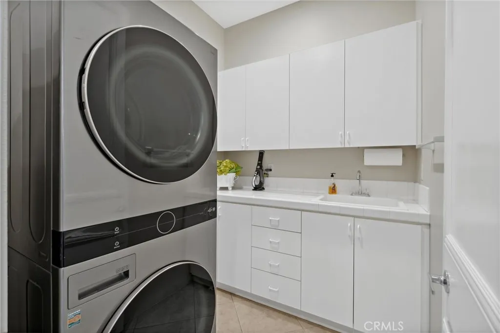 Laundry with full size stacked washer and dryer Laundry with full size stacked washer and dryer