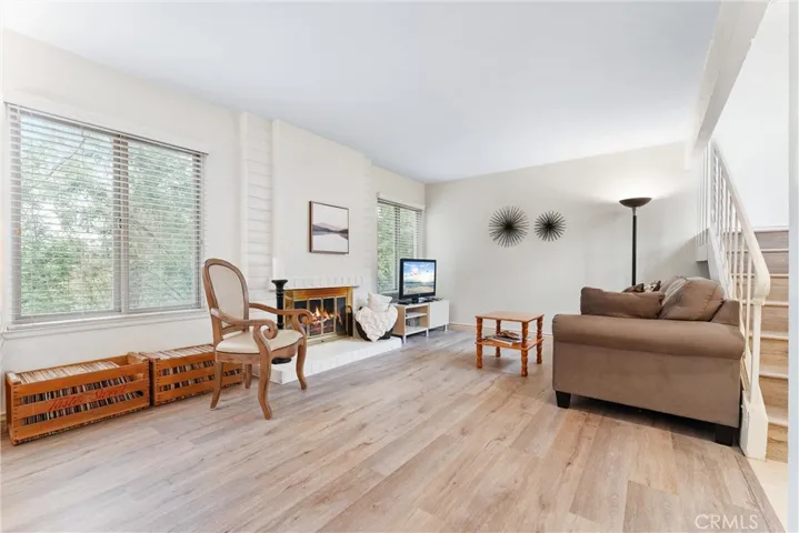 As you enter the front door you are greeted by a large living room with fireplace and windows with views overlooking the hillside.