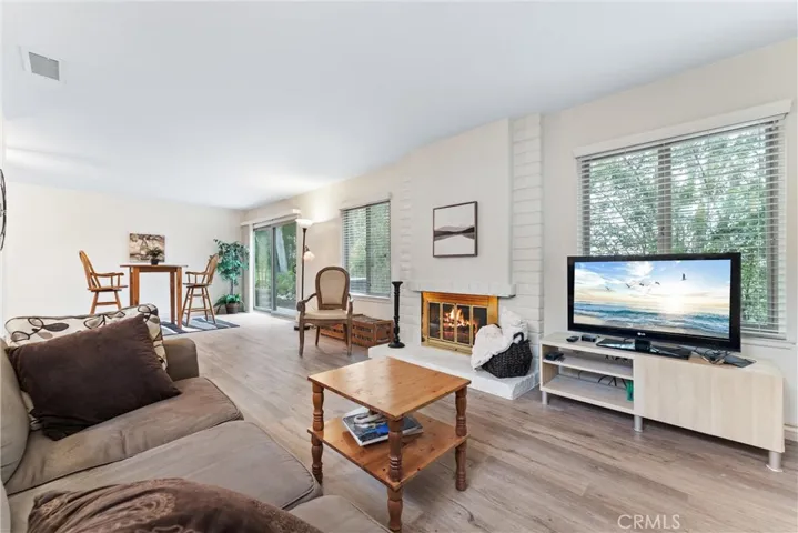 From this angle you are in the living room, see the fireplace, see part of the dining room, and slider that leads to the backyard patio.