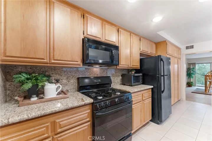 You see plenty of counter space cabinet space and tile flooring.