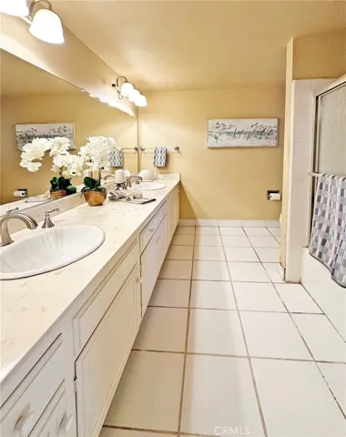 Hall Bath has Tile Flooring and tile Surround Tub/Shwer Combo, Plus Dual Sinks