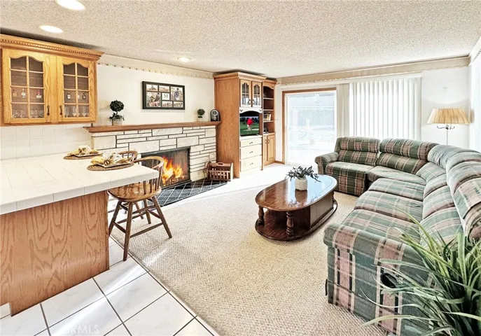 Inviting Family Room with Fireplace and Custom Built-Ins is Open to Kitchen
