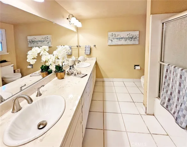 Spacious Hall Bathroom with Dual Sinks and a Tub/Shower Combo