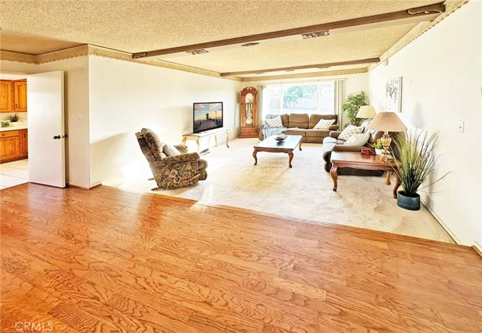 Hardwood Flooring in Foyer and Dining Room and Step-Down Formal Living Room with Open Beam Ceiling
