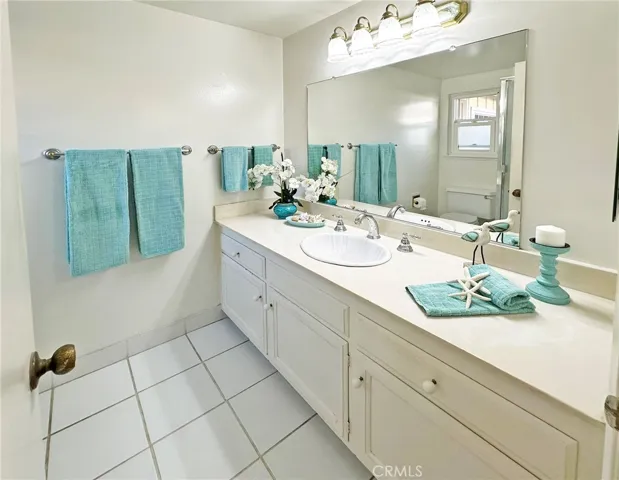 Primary Suite Bathroom with Tile Flooring and Walk-In shower with Tile Surround