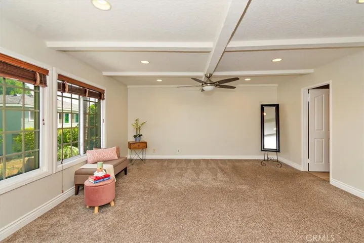 Spacious primary suite features impressive open beam ceiling