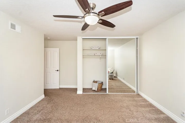 Offering ceiling fan/light and mirror closet doors at bedroom 3