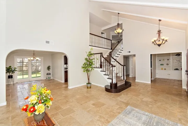Mesmerized by a grand foyer, soaring 2-story high open-beam ceiling that creates a dramatic, inviting atmosphere and a grand sense of airy and open space throughout