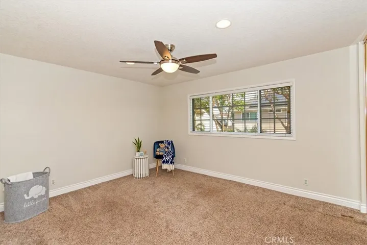 Bedroom 2 is bright and airy with recessed lights and ceiling light/fan