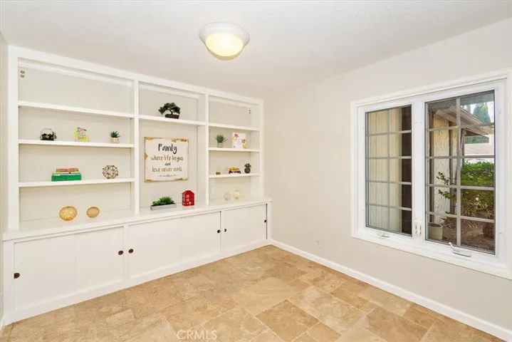 Adjacent to the  ½ bathroom and 3rd tandem garage space, this den also presents the potential for conversion into a desirable downstairs bedroom suite.