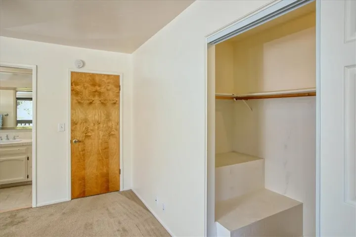 Primary Bedroom: Closet +  Pocket Door to bathroom